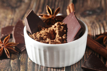 Cocoa powder and a bar of dark chocolate