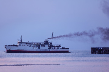 Ferry with smoke coming from stack ,Diesel engine ready to leaving from the harbor