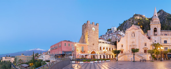 Taormina - The square Piazza IX Aprile and St. Joseph church, Porta di Mezzo gate and Mt. Etna volcano in the background.