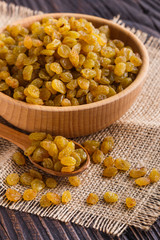 golden raisins on a wooden rustic background © Narsil