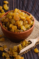 golden raisins on a wooden rustic background