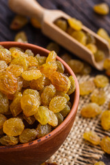 golden raisins on a wooden rustic background