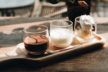 Homemade hot and pure cocoa drink with milk and vanilla ice cream over the wooden table