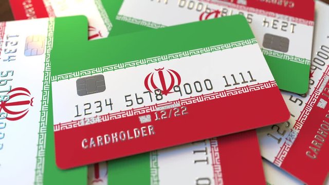 Pile of credit cards with flag of Iran. Iranian banking system conceptual 3D animation