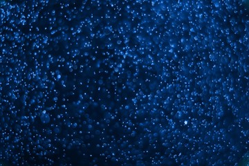 blue plenty of flying celebratory glitters bokeh texture - beautiful abstract photo background