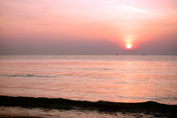 The rising sun view and the beach. Beautiful golden yellow sky and sun The view of the beach