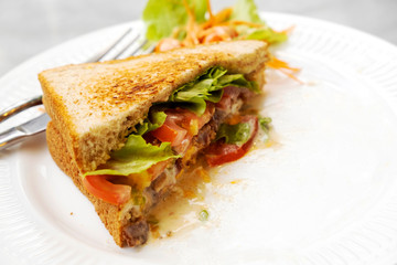 Breakfast, sandwiches, bacon and cheese and vegetables on the marble table