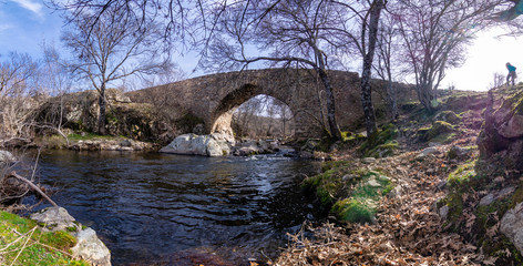 Panoramic view of the Medieval Bridge of Matafrailes, over the creek of Canenciade, one of the Medieval Bridges of Lozoya, Madrid, Spain