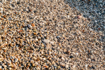 Close up beach stones on the seashore. Summer sunrise on coast, Corfu island, Greece. Beach Ionian sea. Wallpaper