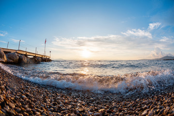 Beach stones on the seashore. Summer sunrise on coast, Corfu island, Greece. Beach Ionian sea. Wallpaper