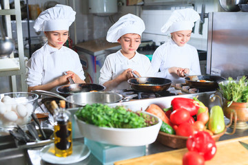 children cooking lunch in a restaurant kitchen.