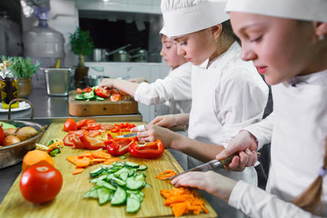 children cooking lunch in a restaurant kitchen.