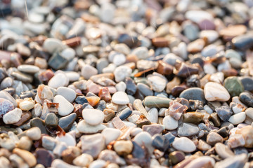 Close up beach stones on the seashore. Summer sunrise on coast, Corfu island, Greece. Beach Ionian sea. Wallpaper