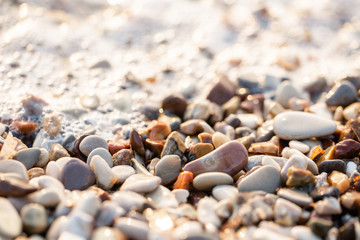 Close up beach stones on the seashore. Summer sunrise on coast, Corfu island, Greece. Beach Ionian sea. Wallpaper