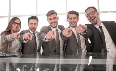 Businessmen in their office pointing to the front