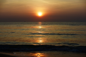 Early morning beach views With a lounge chair When the sun is rising Beautiful golden yellow sky...
