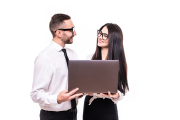 Portrait of a happy business couple looking at laptop computer isolated over white background