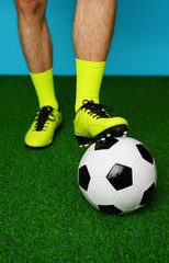 Soccer player with ball on the green grass.