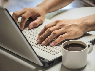 hands typing on laptop