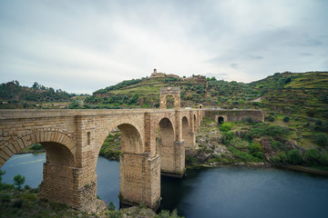 Fototapeta premium The Alcantara Bridge also known as Trajan Bridge at Alcantara is a Roman bridge at Alcantara, in Extremadura, Spain. Slow shutter speed shot.