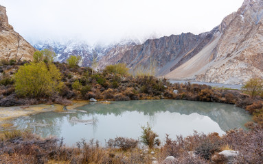 Fototapeta na wymiar Mountains with lake and trees landscape in autumn at Pakistan