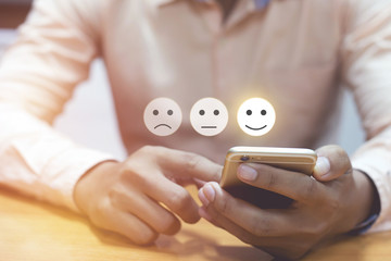 Business man use mobilepressing smiley face touch screen
