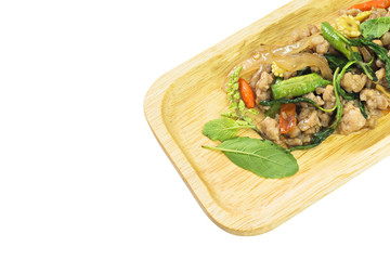 Fried stir basil with minced pork on Wood tray isolated on white background, selective focus (detailed close-up shot)