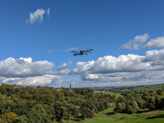 Fototapeta na wymiar drone in flight against blue sky