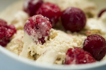  homemade ice cream with frozen cherry and raspberry .   healthy sweets concept