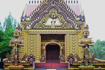 A giant statue in front of the temple of a beautiful Thai temple