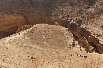 Group hikers in desert mountains.
