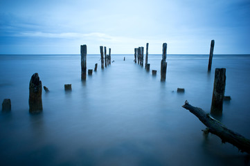 Fototapeta premium Old harbor ruins in Kuldiga. Peaceful blue sea and port. Harbour in Baltic sea, Latvia, Europe