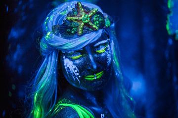 Portret of Water woman.  Body art glowing in ultraviolet light © popovatetiana