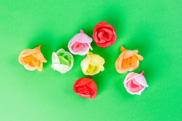 wafer edible paper biscuit rose flower cake decoration on green background red green pink yellow