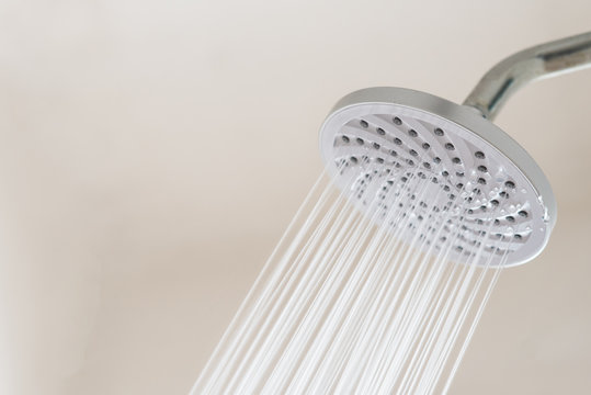 Close up of a Shower head with running water. concept of hygiene and healthcare