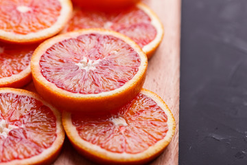 Blood orange cut in circles on a dark background