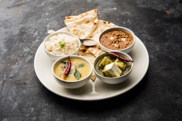 Indian vegetarian  platter / Thali having Palak paneer butter masala, dal makhani, flat bread or...