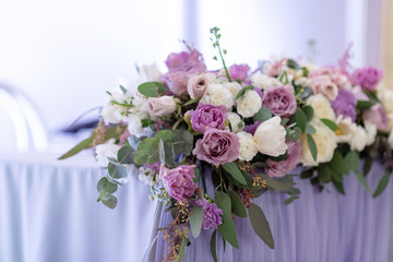 Long and beautiful composition from fresh flowers on a table.