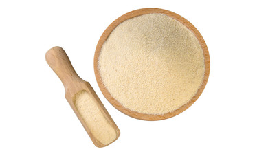 semolina in wooden bowl and scoop isolated on white background. nutrition. bio. natural food ingredient.top view.