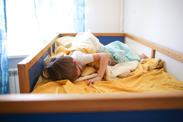 children brother and sister playing on bed,sibling
