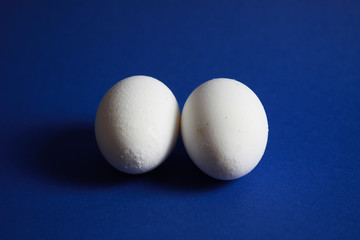 Close up of isolated two eggs with blue background