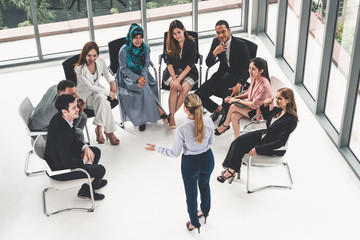 Businesswomen and businessmen attending group meeting conference in office room. Corporate business team concept.