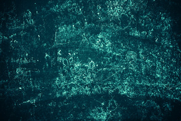 Vintage azure background. Rough painted wall of turquoise color. Imperfect plane of cyan colored. Uneven old decorative toned backdrop of aqzure tint. Texture of teal hue. Ornamental stony surface.