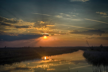 Sunset on the river in the Astrakhan region. Irrigation system for agriculture
