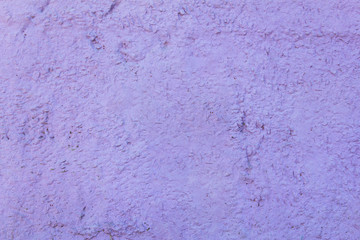 light purple granular concrete wall with a relief. rough surface texture