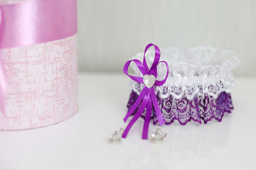 Wedding garter and flowers on a white table