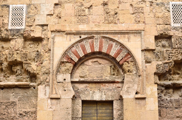 Fototapeta na wymiar Door and facade of Visires o San Esteban, Moorish facade of the Great Mosque in Cordoba, Andalusia, Spain