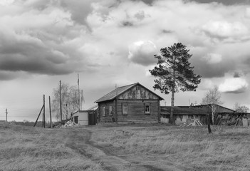 The road leading to the village log house. Monochrome photo