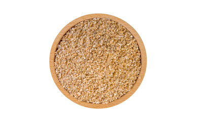 crushed spelt in wooden bowl isolated on white background. nutrition. food ingredient.top view.