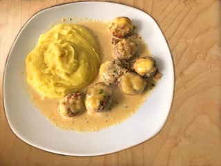 Würzig gefüllte Champions Köpfe mit Käse überbacken, in Kräuter-sahne Soße, dazu luftiges Kartoffelpüree   